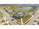 Aerial view of the community clubhouse, pool, tennis courts, and well-maintained lawns at 1853 Summer Serenity Dr, Kissimmee, FL 34744