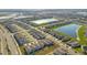 An aerial view captures a community surrounding two ponds, showing tightly packed single Gathering homes at 1853 Summer Serenity Dr, Kissimmee, FL 34744