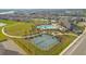 Community amenities including pool, clubhouse, tennis courts, and landscaped grounds in aerial view at 1853 Summer Serenity Dr, Kissimmee, FL 34744
