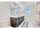 Well-lit bathroom featuring a double sink vanity and large framed mirror at 1853 Summer Serenity Dr, Kissimmee, FL 34744