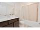 Well-lit bathroom features a vanity with modern fixtures and a bathtub with shower at 1853 Summer Serenity Dr, Kissimmee, FL 34744