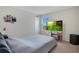 Bright bedroom with a large window, desk, and cozy gray bedding at 1853 Summer Serenity Dr, Kissimmee, FL 34744