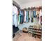 Organized walk-in closet with rods and shelves for clothing and shoes at 1853 Summer Serenity Dr, Kissimmee, FL 34744