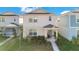 Charming two-story home with a covered front porch and well-maintained lawn at 1853 Summer Serenity Dr, Kissimmee, FL 34744