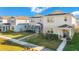 Street view of three modern two-story homes with well-manicured lawns and sidewalks at 1853 Summer Serenity Dr, Kissimmee, FL 34744
