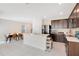 Modern kitchen featuring dark wood cabinets, a central island, and stainless steel appliances at 1853 Summer Serenity Dr, Kissimmee, FL 34744