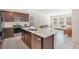 Well-lit kitchen with stainless appliances, center island and seamless flow to living spaces at 1853 Summer Serenity Dr, Kissimmee, FL 34744