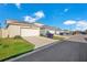 Street-level view of homes with garages and driveways, showcasing the neighborhood's architecture and manicured lawns at 1853 Summer Serenity Dr, Kissimmee, FL 34744