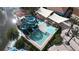 Aerial view of waterpark featuring colorful slides, a splash pad, a pool, green landscaping, and shade structures at 2716 Bushman Dr, Kissimmee, FL 34746