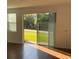Bright living room featuring beautiful wood floors and sliding glass doors to the outdoors at 14315 Swanley St, Orlando, FL 32832