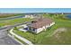 Beautiful aerial view of a well-maintained home surrounded by lush greenery and a picturesque lakeside community at 267 Spinnaker Ct, Auburndale, FL 33823