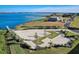 Aerial view of a lakeside community featuring homes, a parking lot, and scenic water views at 267 Spinnaker Ct, Auburndale, FL 33823