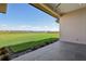 Expansive backyard featuring lush grass and a serene lake view from a tiled patio space at 267 Spinnaker Ct, Auburndale, FL 33823