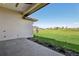 Landscaped backyard with a tiled patio that offers stunning views of a green space and a tranquil pond at 267 Spinnaker Ct, Auburndale, FL 33823
