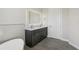 This bathroom features double sinks and a large, lighted mirror at 267 Spinnaker Ct, Auburndale, FL 33823