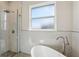 This bathroom features a glass enclosed shower and freestanding tub at 267 Spinnaker Ct, Auburndale, FL 33823