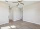 This bedroom has wood-look tile flooring and a ceiling fan at 267 Spinnaker Ct, Auburndale, FL 33823