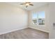 This bedroom has wood-look tile flooring and a view from the window at 267 Spinnaker Ct, Auburndale, FL 33823