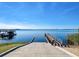 Scenic view of a boat ramp leading into a serene lake with a covered boat dock at 267 Spinnaker Ct, Auburndale, FL 33823