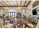 Elegant clubhouse lounge area with chandeliers, comfortable seating, and a cozy fireplace at 267 Spinnaker Ct, Auburndale, FL 33823