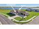 Beautiful new construction home with paver driveway, lush lawn, and incredible lake views at 267 Spinnaker Ct, Auburndale, FL 33823