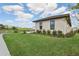 Well-maintained single-Gathering home with fresh landscaping, a green lawn, and a modern neutral color scheme at 267 Spinnaker Ct, Auburndale, FL 33823