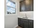 This laundry room features gray cabinets, sleek countertops, and a window with a view of the outdoors at 267 Spinnaker Ct, Auburndale, FL 33823