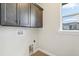 This laundry room provides convenience with a wash hookup, electrical outlet, and a view from the window at 267 Spinnaker Ct, Auburndale, FL 33823