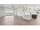 Spacious open concept living room with large tile flooring, tray ceilings, and lots of natural light at 267 Spinnaker Ct, Auburndale, FL 33823