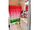 Bathroom features a vanity sink, modern fixtures, and colorful shower curtain at 319 Celebration Blvd, Celebration, FL 34747