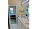 Bright bathroom featuring a double sink vanity with light countertop and large mirror with Hollywood style lighting at 319 Celebration Blvd, Celebration, FL 34747