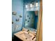 Small bathroom with a blue wall and light countertop at 319 Celebration Blvd, Celebration, FL 34747