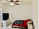 Bedroom with a ceiling fan and light, carpet and a small television with a chest of drawers at 319 Celebration Blvd, Celebration, FL 34747