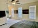 Bedroom featuring a dresser, two windows, and a bed at 319 Celebration Blvd, Celebration, FL 34747