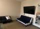 Bedroom includes a sofa, loveseat, glass top coffee table, and mounted television at 319 Celebration Blvd, Celebration, FL 34747