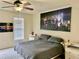 Bedroom featuring a large bed, nightstands, and an eye-catching city skyline triptych above the bed at 319 Celebration Blvd, Celebration, FL 34747