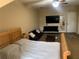 Cozy bedroom featuring a large bed, comfortable seating area, and a mounted television at 319 Celebration Blvd, Celebration, FL 34747