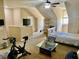 Bright bedroom featuring sloped ceilings, comfortable furniture, and a ceiling fan at 319 Celebration Blvd, Celebration, FL 34747