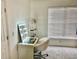 Bedroom featuring a well-lit vanity with a mirror, shelf for storage, carpet, and a window with blinds at 319 Celebration Blvd, Celebration, FL 34747