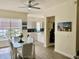 Well-lit dining room with open view to kitchen, featuring tile floors, modern furnishings and bright windows at 319 Celebration Blvd, Celebration, FL 34747