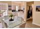 View from a dining room with tile floor to an open kitchen with modern cabinets and countertops at 319 Celebration Blvd, Celebration, FL 34747