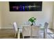 Bright dining room featuring a glass table, four chairs, and city skyline wall art at 319 Celebration Blvd, Celebration, FL 34747