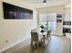 Bright dining room featuring a glass table, four chairs, and city skyline wall art for a modern and elegant dining experience at 319 Celebration Blvd, Celebration, FL 34747