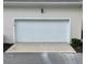 Exterior view of the garage door with a dark, exterior light fixture at 319 Celebration Blvd, Celebration, FL 34747