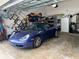 Interior view of the garage with a car and bicycle parked inside with lots of storage at 319 Celebration Blvd, Celebration, FL 34747