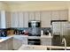 Bright kitchen boasts gray cabinetry and stainless steel appliances at 319 Celebration Blvd, Celebration, FL 34747