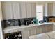 Bright kitchen boasts gray cabinetry and quartz counters with lots of appliances on display at 319 Celebration Blvd, Celebration, FL 34747