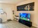 A comfortable living room showcasing a television, a gray floor, and London-themed wall art at 319 Celebration Blvd, Celebration, FL 34747