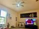 Bright living room features golf on television, cityscape wall art, and casual seating area at 319 Celebration Blvd, Celebration, FL 34747