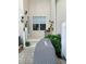 Outdoor patio area, showcasing the steps leading to the door, lush plants, and outdoor grill at 319 Celebration Blvd, Celebration, FL 34747